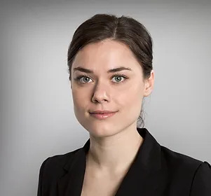 A woman in black jacket and white shirt