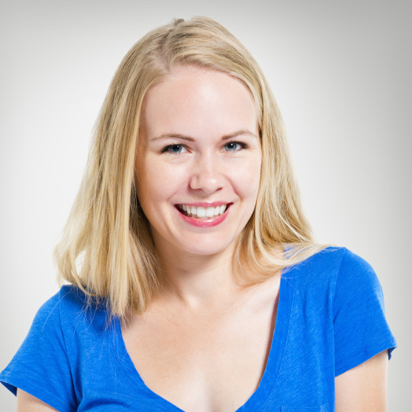 A woman in blue shirt smiling for the camera.