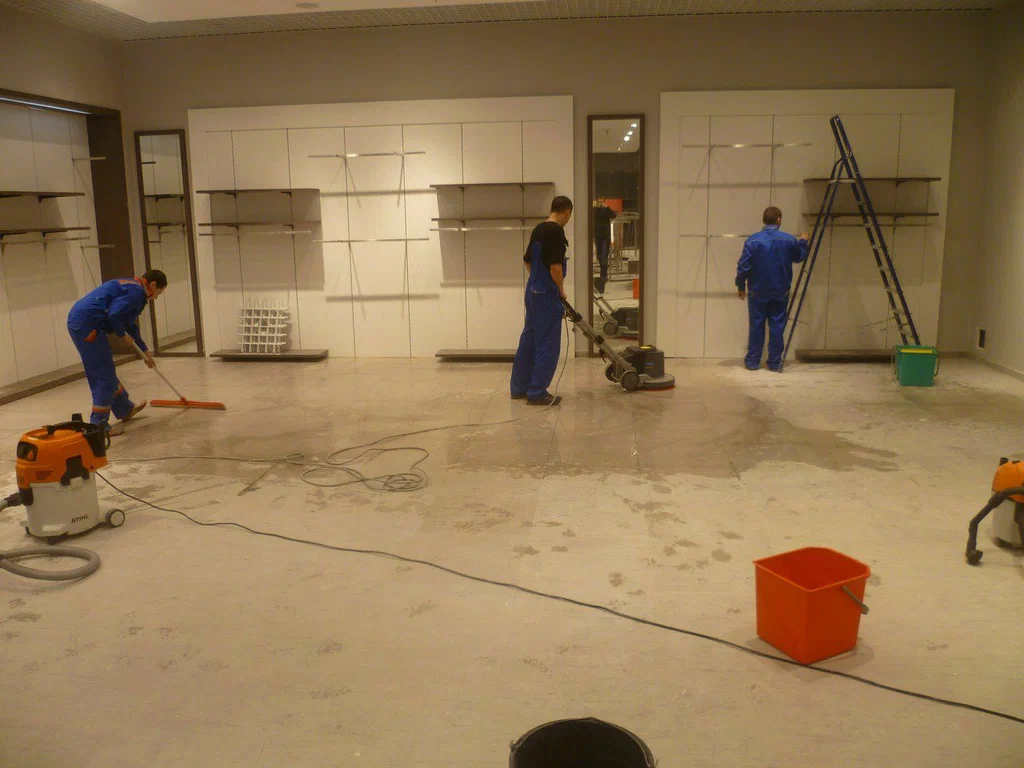 A group of men working on the floor in an office.