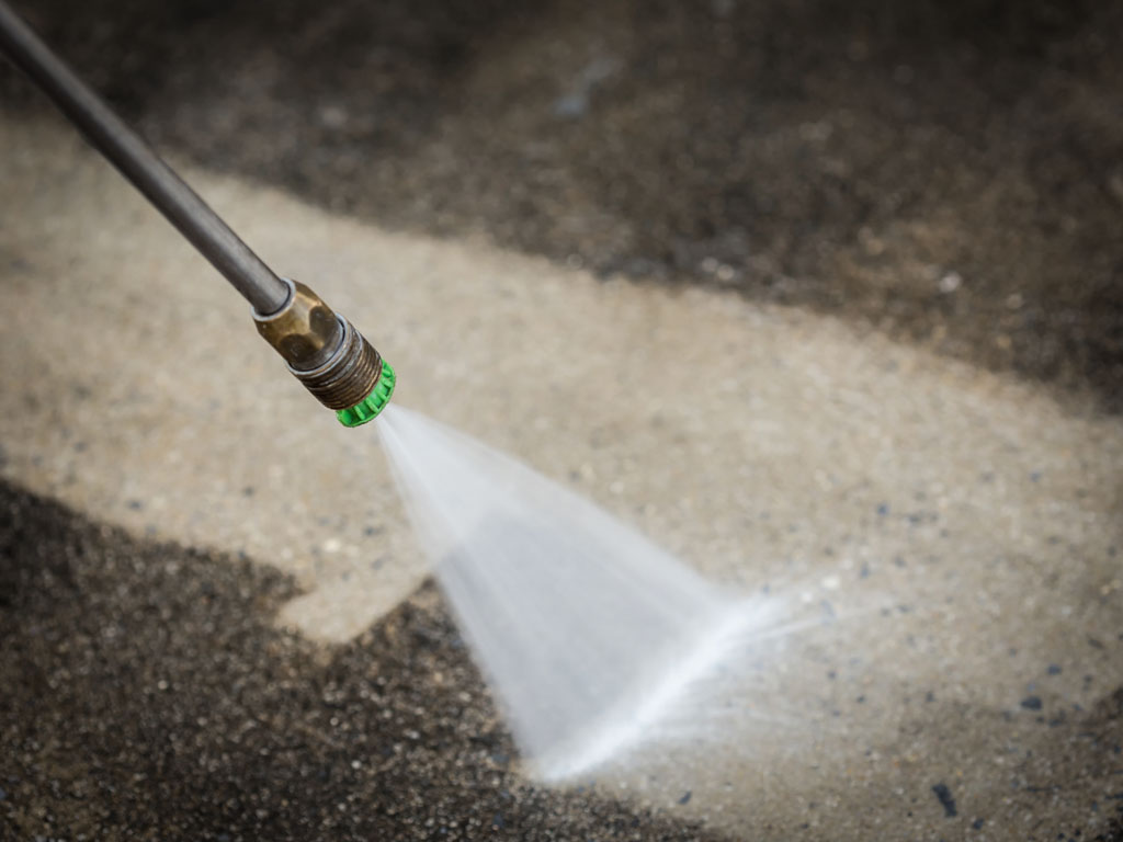 A hose spraying water on the ground.