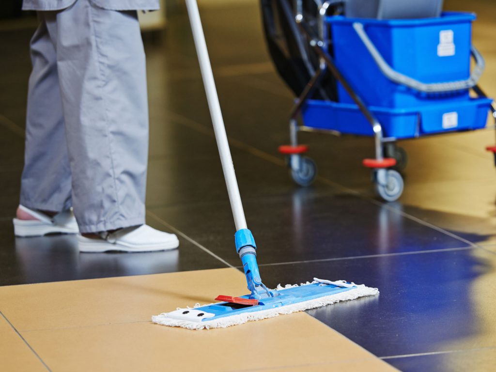 A person is mopping the floor with a mop.